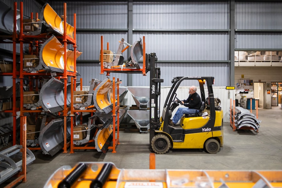 Rick Lennox, operations manager at Arctic Snowplows, stacks completed plows at the company's facility in London, Ont. The company is getting hit with a 50-per-cent duty on the steel content in its finished product. 