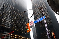 People cross Bay St. in Toronto's Financial District on Tuesday, January 6, 2026.   