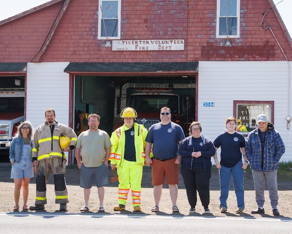 Volunteer firefighters line up in front of the fire station in Tiverton, Nova Scotia, in May, 2026. The building has been condemned since 2014.