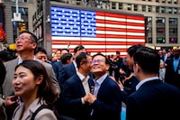 FILE PHOTO: Employees of memory chip company SK Hynix attend the company's opening bell ceremony at the Nasdaq market on the day of their IPO in New York City, U.S., July 10, 2026. REUTERS/Angelina Katsanis/File Photo