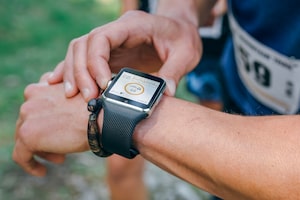 Unrecognizable sportsman looking at a smartwatch outdoors