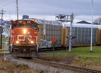 A CN Rail locomotive pulls auto carrier cars in Dartmouth, N.S. on Thursday, Nov. 25, 2021. THE CANADIAN PRESS/Andrew Vaughan