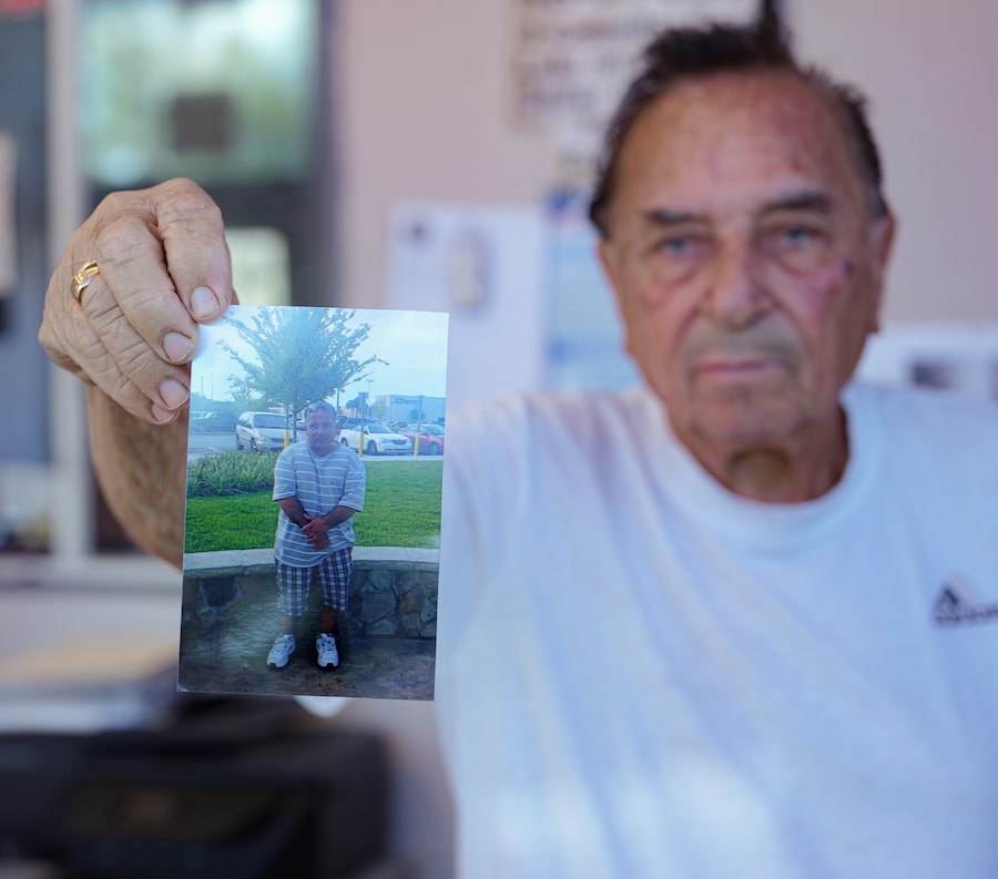 Angelo Noviello with a picture of his son, Johnny Noviello. Johnny, a Canadian, died in ICE custody.
