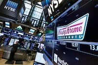 FILE - The Krispy Kreme logo appears above its trading post on the floor of the New York Stock Exchange, Monday, May 9, 2016. (AP Photo/Richard Drew, File)