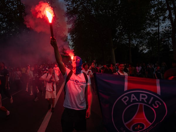 Paris Saint-Germain fans celebrate their team's victory over Arsenal in the UEFA Champions League final, near the Parc des Princes stadium in Paris on Saturday.
