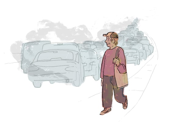 A man walks happily by the side of a busy road filled with cars.