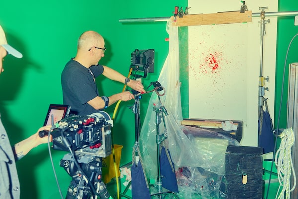 BLOODY OLD-SCHOOL Not every effect is created digitally. For blood splatter, VFX photographers Jean-François Massé (right) and Antoine Bordeleau fire red liquid through a pipe