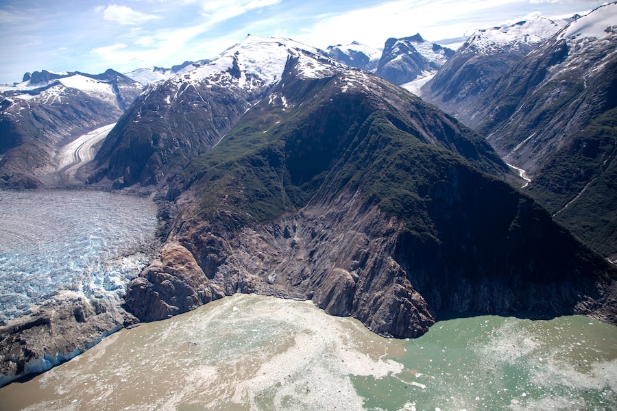 Three days before a survey team took this photo in Alaska’s Tracy Arm, a tsunami – triggered by a landslide on the other side of the fjord – stripped away the vegetation on the slopes at middle.