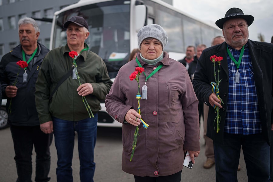 Workers who helped clean up contamination from the Chornobyl nuclear power plant disaster place flowers on a monument to their fallen comrades on April 21, 2026.