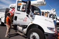 Hydro One workers at the Husky Travel Centre in Niagara-on-the-Lake, Ont., in September, 2017. Share prices for Hydro One gained more than 93 per cent over the past five years.
