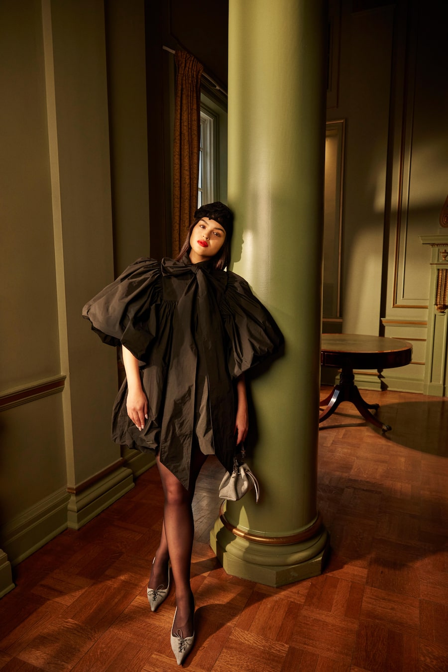 Anna Lambe wears a Vaquera dress and lace hat (through ssense.com), with leather heels and bag from Jimmy Choo (jimmychoo.com).