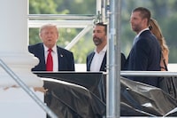 President Donald Trump with his sons Donald Trump Jr. and Eric Trump, stop on looks at the construction work on the North Portico as he leaves the White House to travel to Medora, N.D. for the opening of the Theodore Roosevelt Presidential Library, Wednesday, July 1, 2026, in Washington. (AP Photo/Manuel Balce Ceneta)