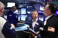 Traders work on the floor of the New York Stock Exchange (NYSE) at the opening bell in New York City on April 7, 2026. Oil prices jumped Tuesday and stocks fell after US-Israeli strikes on the key Iranian oil export terminal of Kharg island, with investors bracing for US President Donald Trump's looming deadline for Iran to reopen the Strait of Hormuz or face devastating attacks. (Photo by CHARLY TRIBALLEAU / AFP via Getty Images)