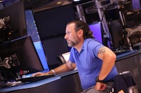 Traders work on the floor of the New York Stock Exchange during afternoon trading on July 26.
