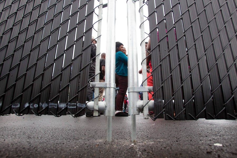  Refugees who made an irregular crossing at the Canada-U.S. border wait in a temporary detention centre in Blackpool, Que., in August, 2017.