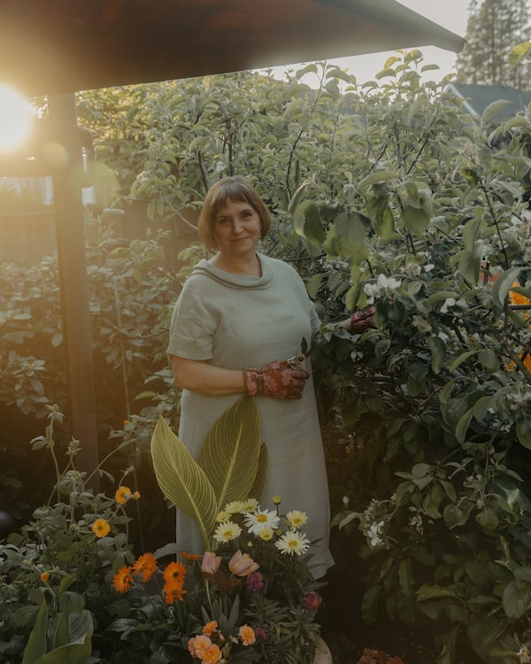 Leanne Johnson, president and chief executive of Gardenworks, tends to flowers in her backyard in North Vancouver. 