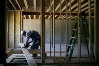 A contractor cuts lumber while installing a staircase at a home under construction at the Toll Brothers Inc. Cattail Overlook development in Glenelg, Maryland, U.S., on Thursday, May 30, 2013.  