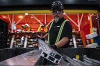 Components of electric vehicle battery trays are prepared to be welded at Magna's Heart Lake production facility, where they are currently manufacturing battery enclosures for Ford F-150s, in Brampton, Ont., Thursday Aug. 3, 2023. (Christopher Katsarov/The Globe and Mail)