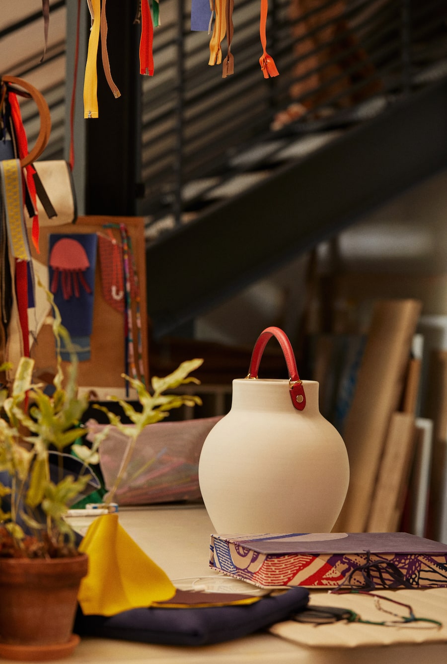 At Petit H studio, a piece of terracotta pottery is accented with a handle from a Hermès Kelly handbag.