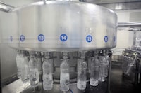 Water is filled into bottles made from a byproduct of polymer resin at a manufacturing plant in Dhaula Kuan, India.