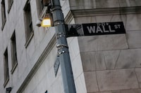 The Wall Street sign outside the New York Stock Exchange (NYSE) building in New York City, U.S., March 11, 2025. 
