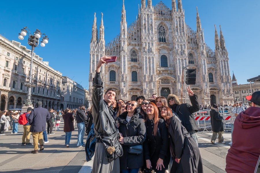 This KIKO makeup team will be busy dolling up performers at the Olympic opening ceremony, but the day before, they have time for some sightseeing at Milan’s Piazza del Duomo, named for its historic cathedral.