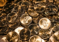 Loonies with the the effigy of King Charles on them are struck at an event celebrating the first coin struck at the Royal Canadian Mint in Winnipeg on Tuesday, November 14, 2023. THE CANADIAN PRESS/John Woods