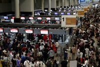 Air Asia passengers queue at counters inside Don Mueang International Airport Terminal 1 amid system outages disrupting the airline's operations, in Bangkok, Thailand, July 19, 2024. REUTERS/Chalinee Thirasupa