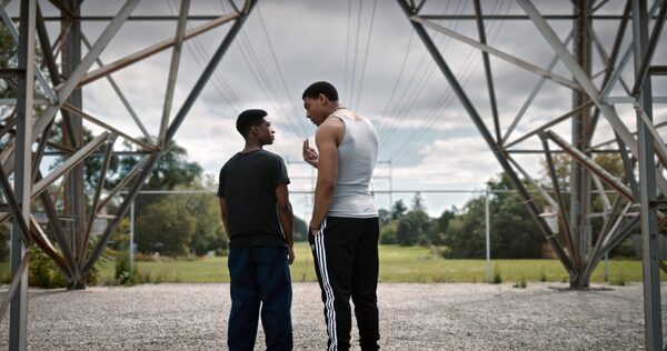 BROTHER (2022). Francis (Aaron Pierre) and Michael (Lamar Johnson) are brothers who immigrated to Canada in the 1990s and are fiercely protective of each other. Francis, in particular, has his foot in different worlds: one of violence and danger and the other of his family. The film also follows Michael as he navigates a suburban landscape and his own temptations with the dark side. Courtesy of Elevation Pictures