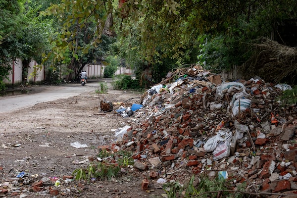 Broken asbestos roofing tiles can be seen at a dump in central New Delhi, India on September 24, 2023. If not properly disposed of, asbestos fibres can become airborne and potentially cause health problems.