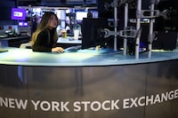 A trader works on the floor of the New York Stock Exchange (NYSE) before the closing bell in New York, on April 24, 2026. Major Wall Street indices closed at fresh records as markets cheered the latest batch of earnings reports and US and Iranian officials headed to Pakistan for expected peace talks. (Photo by CHARLY TRIBALLEAU / AFP via Getty Images)