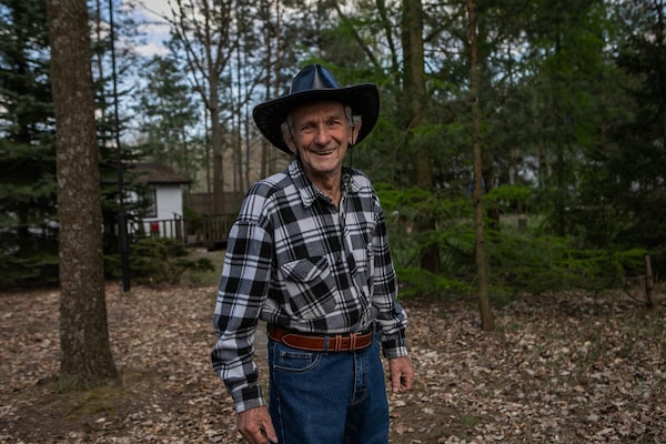 Andrzej Krolicki, 83, wearing a cowboy-style hat during a family barbecue.