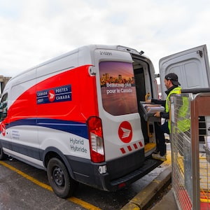 A Canada Post worker fills his truck with mail in Montreal on Tuesday, Dec.17, 2024. THE CANADIAN PRESS/Christinne Muschi