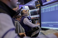 Traders work on the floor at the New York Stock Exchange (NYSE) in New York City, U.S., May 27, 2026. REUTERS/Jeenah Moon/File Photo