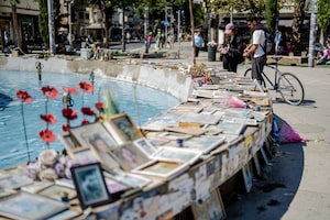 People gather in Dizengoff Square where pictures of people killed on Oct. 7, 2023 are placed on April 21, in Tel Aviv, Israel.