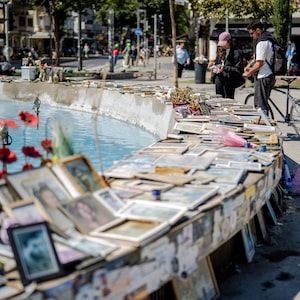 People gather in Dizengoff Square where pictures of people killed on Oct. 7, 2023 are placed on April 21, in Tel Aviv, Israel.