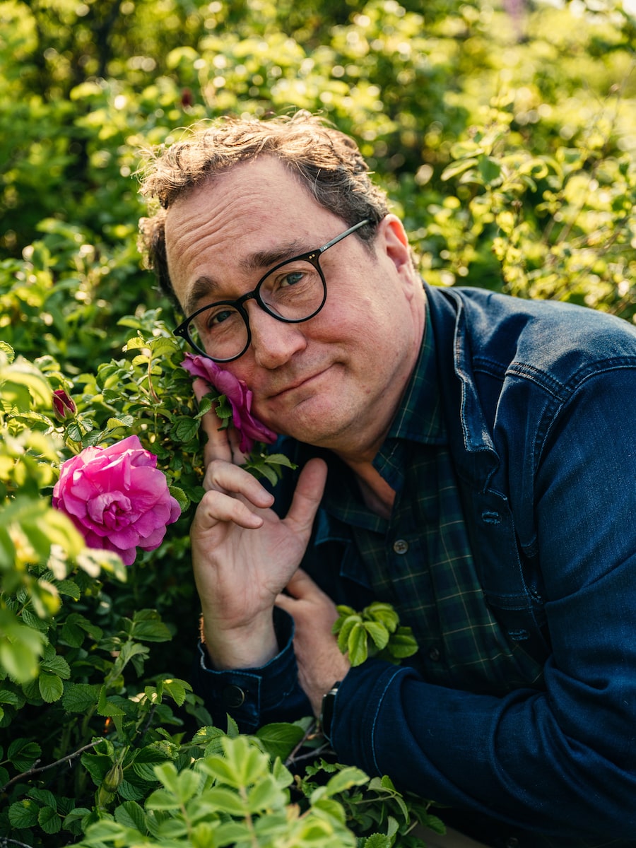 Mark Critch on the now-empty lot where his childhood home once stood where the rose bushes his mother planted decades ago still bloom.