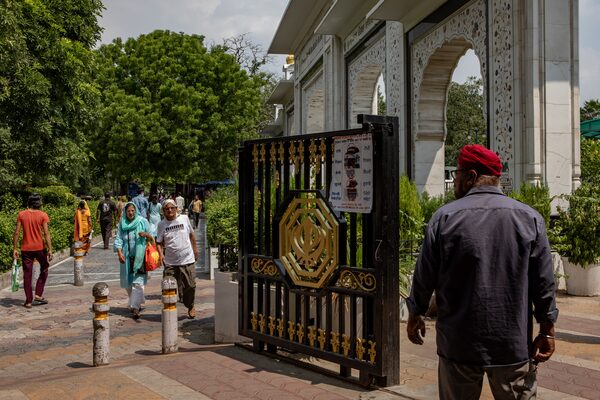 Worshippers and tourists walk past the entrance to Gurdwara Bangla Sahib, a Sikh temple in central New Delhi, India, on September 20, 2023.