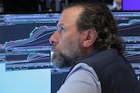 Traders work on the floor of the New York Stock Exchange during morning trading on April 20, 2026 in New York City. 