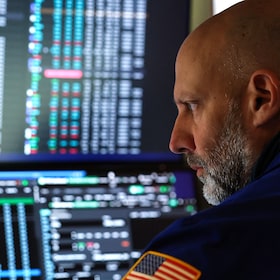 A trader works on the floor of the New York Stock Exchange (NYSE) at the opening bell in New York on April 16.
