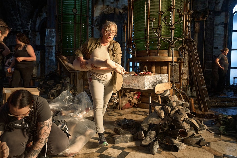 Production Designer Tamara Deverell with crew members on the set of Frankenstein.