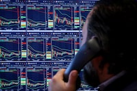 A trader works on the floor at the New York Stock Exchange in New York City, U.S., April 8, 2025.  