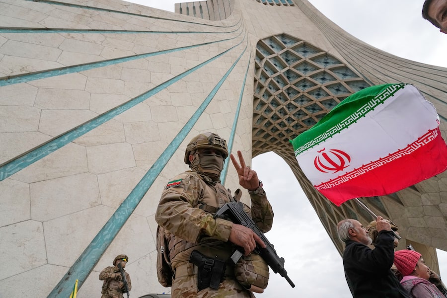 A Revolutionary Guard member patrols the Azadi monument in Tehran on Feb. 11 during anniversary celebrations of Iran's 1979 revolution. Two weeks later, Iran would be under U.S. and Israeli missile fire that killed Iran's Supreme Leader, who the guard answers to directly.