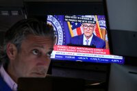 FILE PHOTO: A trader works, as a screen broadcasts a news conference by U.S. Federal Reserve Chair Jerome Powell following the Fed rate announcement, on the floor of the New York Stock Exchange (NYSE) in New York City, U.S., June 12, 2024.  REUTERS/Brendan McDermid/File Photo