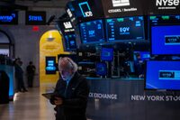 Traders work on the New York Stock Exchange (NYSE) floor on August 8.