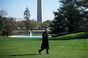 Trump walks across the South Lawn of the White House yesterday.