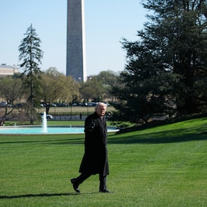 Trump walks across the South Lawn of the White House yesterday.