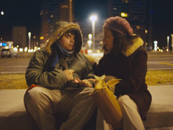 L to R: Isaiah Lehtinen (Lawrence) and Romina D'Ugo (Alana) in I LIKE MOVIES. Photo courtesy of VHS Forever Inc.