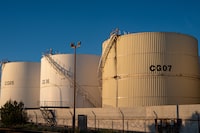 (FILES) This general view shows storage tanks at the Lavera oil refinery in Martigues, southern France on March 17, 2026. Oil inventories held by OECD member countries fell in May to their lowest level since 1990 as governments drew down stocks to offset the blockage of Gulf crude shipments during the Mideast war, the International Energy Agency said June 17, 2026. (Photo by Elodie CLEMENT / AFP via Getty Images)