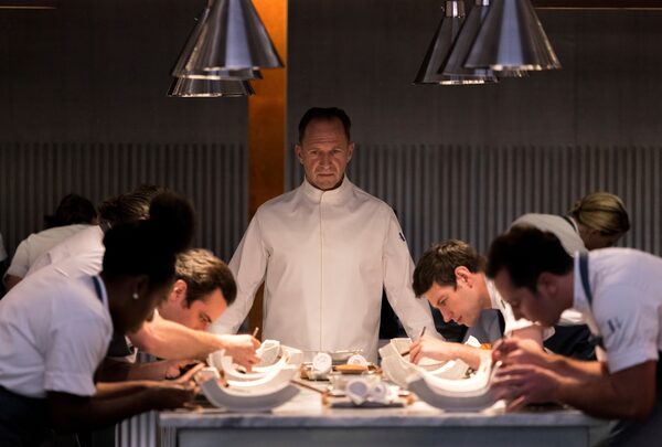 This image released by Searchlight Pictures shows Ralph Fiennes, center, in a scene from the film "The Menu." (Eric Zachanowich/Searchlight Pictures via AP)